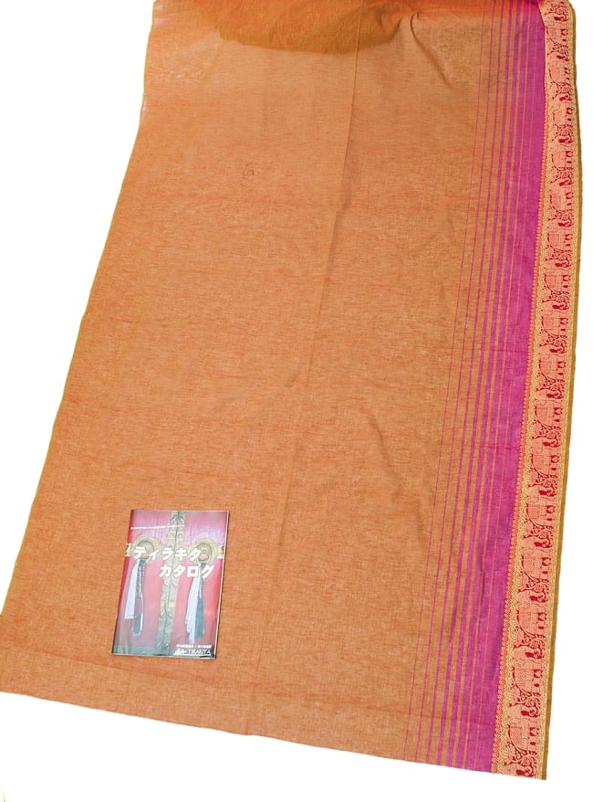 〔1m切り売り〕南インドのハーフボーダー・シンプル・コットン生地 - オレンジブラウン×赤象さん〔幅約110cm〕の写真1枚目です。A4の冊子と撮影しました布の広がりがわかりますね。切り売り,量り売り布,アジア布 量り売り,手芸,裁縫,生地,アジアン,ファブリック
