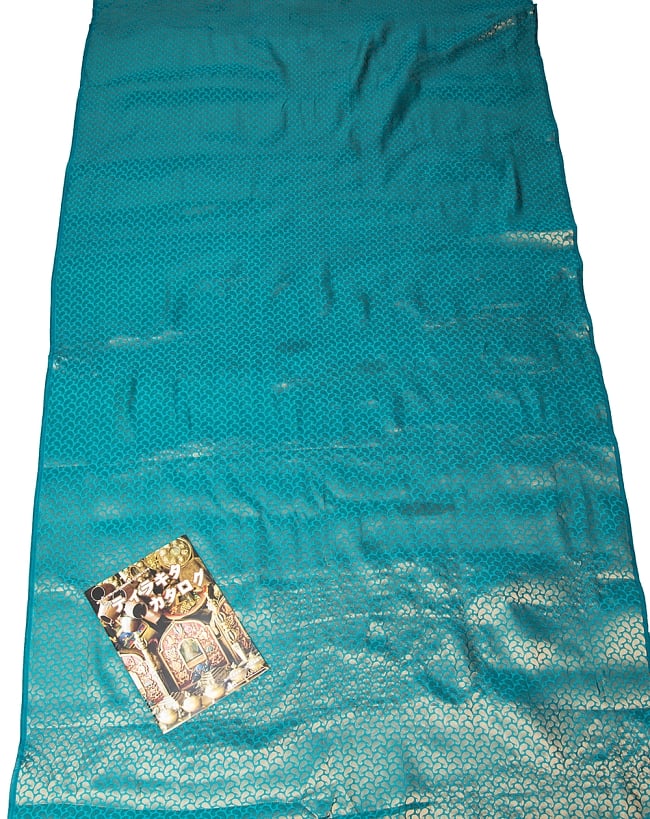 〔1m切り売り〕インドの伝統模様布 ブルー・グリーン＆ゴールド〔幅約110cm〕 7 - A４冊子と比較撮影しました。これくらいのサイズ感になります。