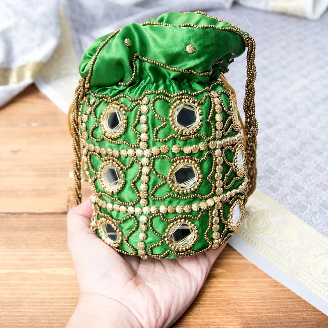 華やかなゴールドビーズ＆ミラーワークの巾着ミニポーチ　ミニバッグ - オレンジ 9 - サイズ比較のため手に持ってみました。（写真は類似商品です。）